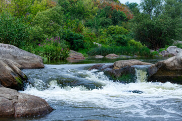 Mountain river with clean water and green landscape, nature background.