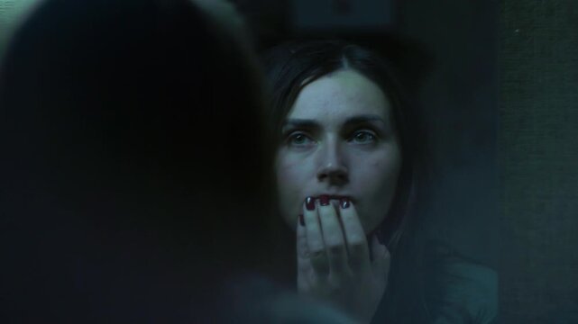 A woman stares at her reflection in the mirror, touching her face with a broken, overwhelmed expression. A cinematic moment of self-doubt, exhaustion, and emotional struggle. 