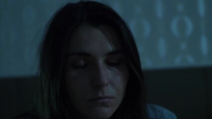 A woman sits on her bed at night with trembling, unfocused eyes. A symbolic cinematic scene representing dependency, loss of control, emotional instability, and inner conflict. 