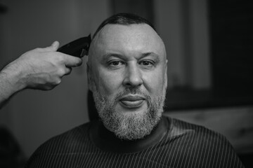 Male caucasian adult receiving haircut in barbershop, banner barber shop concept