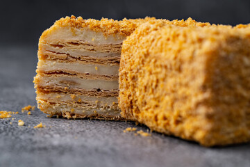 Napoleon Cake Slices with Crumb Coating on a Rustic Stone Background