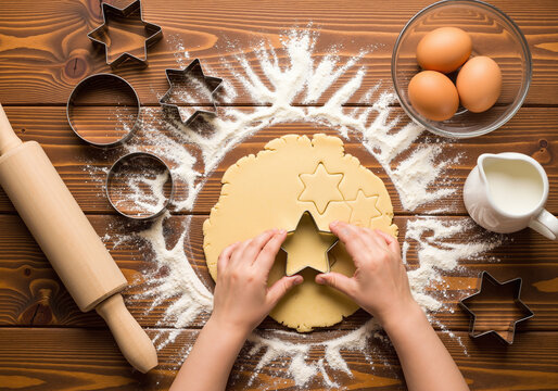 Top view of a child's hands baking star-shaped cookies for Christmas on a rustic wooden table with ingredients. - Powered by Adobe