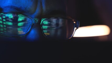 Investor's glasses reflecting stock market and cryptocurrency charts in a dark room - Powered by Adobe
