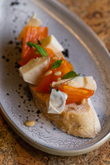 Gourmet Crostini with Brie Cheese, Persimmon, and Pine Nuts