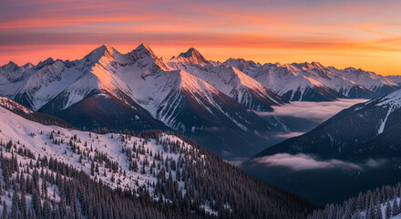Aerial view of snow-covered mountain range at sunrise, featuring jagged peaks and distant fog, representing wilderness, adventure and natural grandeur