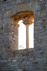 Double lancet window (bifora) on the first floor of the Rocca di Campiglia Marittima, archaeological park in Tuscany, Italy