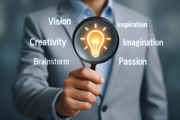Creative business vision concept with magnifying glass and glowing bulb highlighting innovation imagination and brainstorming ideas