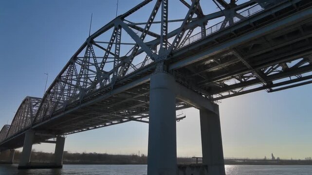 a massive steel bridge stretching across a wide river