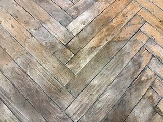 Old dirty, damaged and scratched wooden parquet floor needing restoration