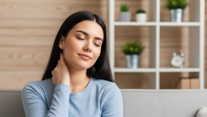 Young woman touching her neck with closed eyes, showing relief or relaxation indoors