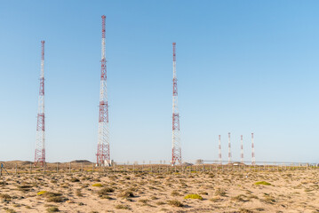 Group of transmission towers and communication antennas located in a desert area of Oman.