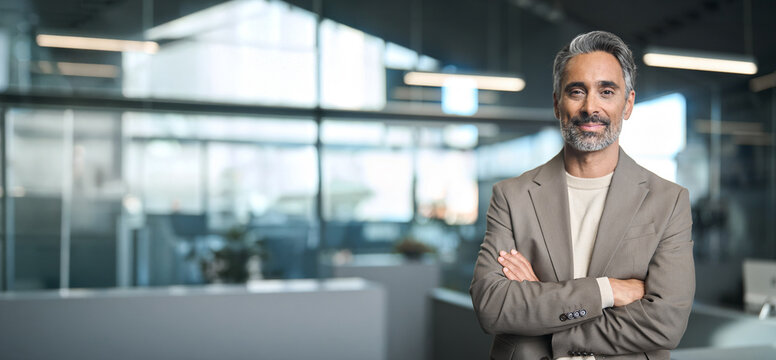 Mature male entrepreneur, rich confident business owner, happy middle aged older professional business man, smiling mature executive ceo manager standing in office looking at camera, portrait. Banner
