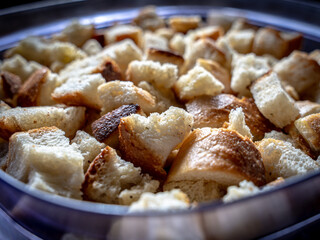 Close up of a plastic bowl filled with toasted bread croutons