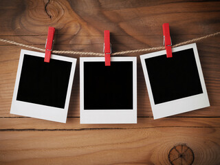 Create a charming gallery wall with these nostalgic blank instant frames hanging on a rustic string, perfect for sharing memories and inspiration