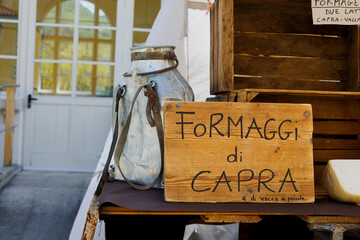 Wooden sign advertising goat cheese for sale