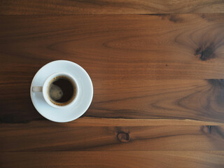 Enjoy a moment of pure bliss with this dark espresso on a rich wooden table, perfect for lifestyle blogs or coffee shop menus, morning vibes