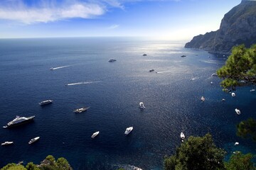 Magnificent motor and sailing yachts at anchor on the south side of the island of Capri, Italy.