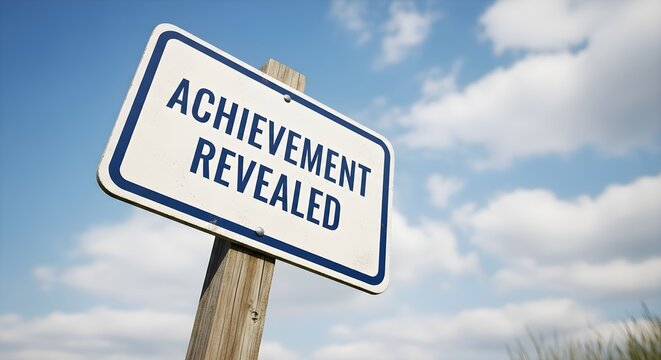 Achievement Revealed Sign Standing Tall Against a Bright Blue Sky with Fluffy Clouds