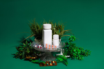 pill holder with greenery on green background