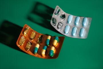 packs of pills on green background