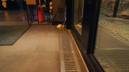 Realtime footage captures urban textures with reflective glass and streetlights in background