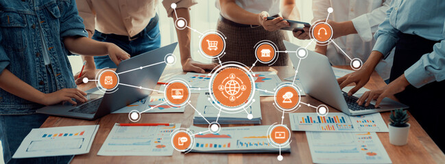 A dynamic workspace scene showcasing a diverse team analyzing data on laptops, focusing on digital trends and strategies for improved communication and insight. Amity