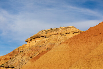 Fototapeta premium Majestic sandstone formations rise against a clear blue sky in the vast desert landscape