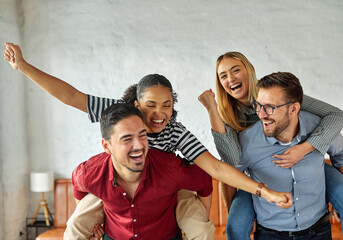 Portrait of a group of young business people having fun jumping rope during a meeting in the office. Teamwork and success concept