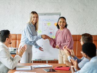 Group of young business people having a meeting shaking hands handshake introducing each other, introduction of a new colleague emplyee in the office