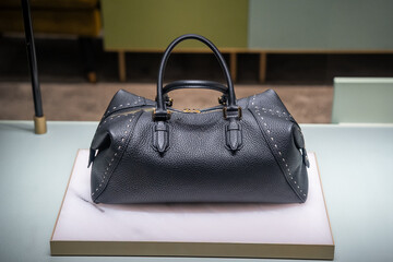 Luxurious Black Leather Handbag Display on Elegant Stand