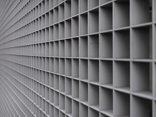 Abstract white grid pattern showing geometric perspective with shallow depth of field and repetitive structure.