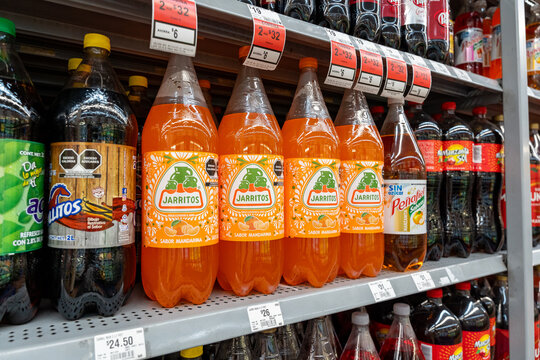 Mandarin flavored Jarritos soda glass bottles displayed at Walmart. Novamex, Foque brand, originated in Mexico City, Mexico (since 1950). Jalisco, Mexico, December 4, 2025. refresco.
