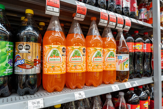 Mandarin flavored Jarritos soda glass bottles displayed at Walmart. Novamex, Foque brand, originated in Mexico City, Mexico (since 1950). Jalisco, Mexico, December 4, 2025. refresco.