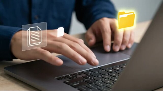 Person's Hands on Laptop with Glowing Virtual File and Folder Icons, Symbolizing Digital Data Management and Cloud Storage