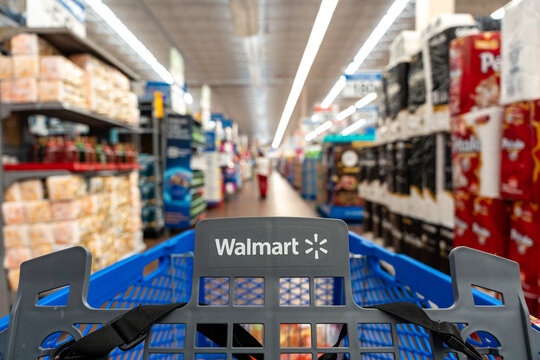 Walmart cart (first-person view) moving down an aisle. Walmart Inc. brand, originated in Bentonville, USA. Guadalajara, Jalisco, December 4, 2025.
