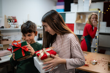 Children unwrapping christmas gifts with surprise and disappointment