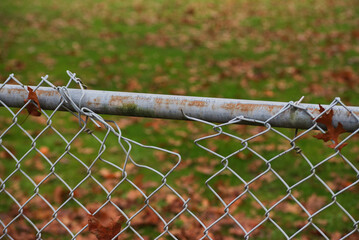 Naklejka premium Broken chain link fence