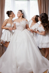 Fototapeta premium Bridal party celebrates together in elegant bridal suite before wedding ceremony