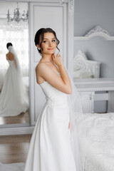 Fototapeta premium Beautiful bride preparing in elegant room with soft lighting and stylish decor