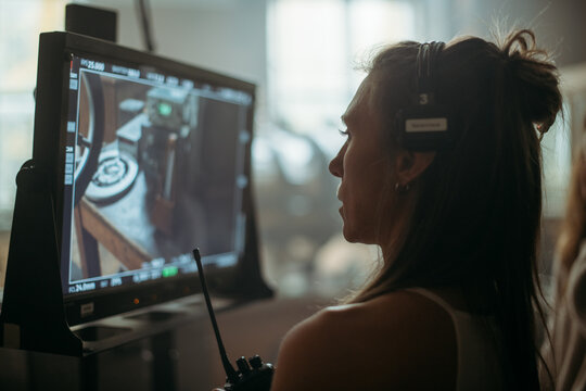 Director at work on the set. The director works with a group or with a playback while filming a movie, advertising, or a TV series. Shooting shift, equipment and group. Modern photography technique.