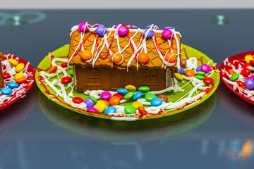 Close up of gingerbread house with colorful candies and icing, a festive handmade Christmas treat. Sweden.