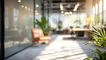 Obraz premium Blurred modern office interior with natural light and greenery