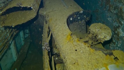 Camera moving forwards above automobile lying on its side inside hold of wreck Salem Express ferry, Slow motion, Close up of machine in the luggage compartment of the sunken ship