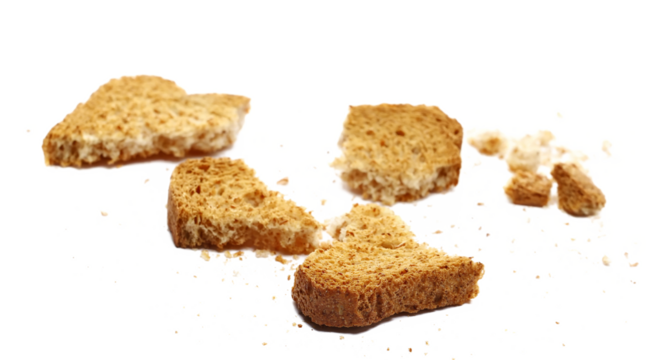 Broken rusks with wholewheat flour, pieces whole wheat dry bread with crumbs isolated on white background, side view