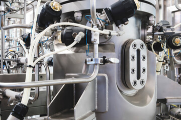 Medical pharma production machine with many tubes and other devices in pharmaceutical factory, pharmaceutical medical production concept background.