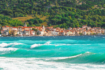 Charming coastal mediterranean village with vibrant blue sea and red rooftops. Ba&scaron;ka, Krk island, Croatia