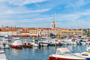 Scenic coastal town with boats and historic architecture. Town of Krk, Krk island, Croatia
