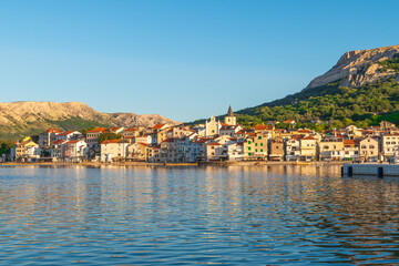 Scenic coastal town and mountain landscape at sunset. Baška, Krk island, Croatia
