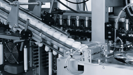 Machine for producing plastic beverage bottles using extrusion method from plastic preformed PET capsules.