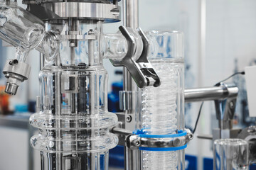 Medical pharma production machine with many tubes and other devices in pharmaceutical factory, pharmaceutical medical production concept background.